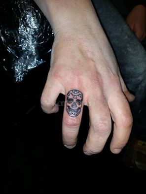 Skull finger tattoo